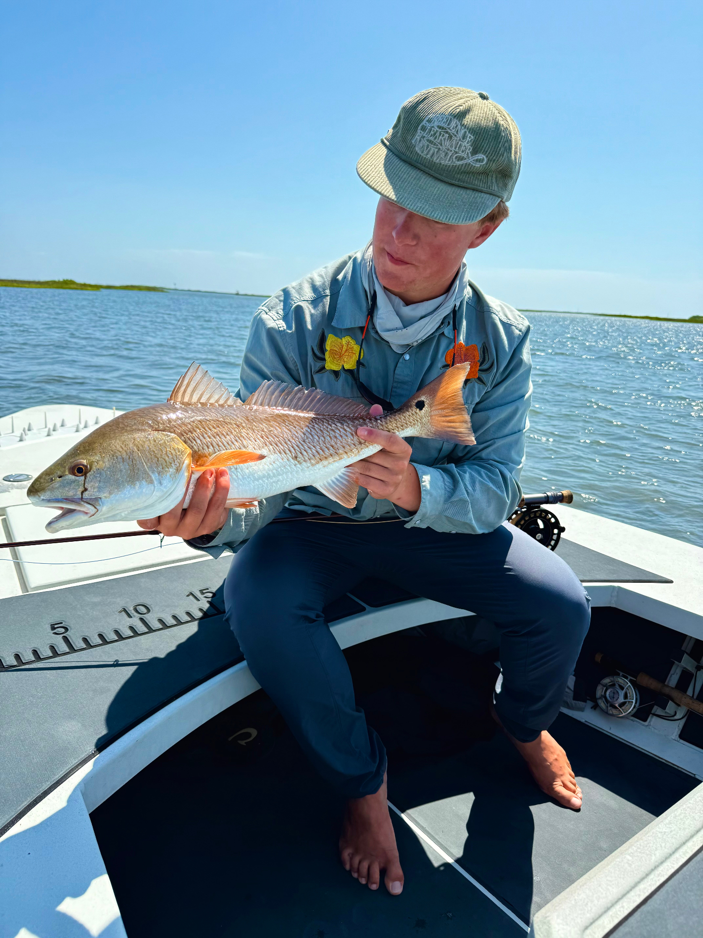 Owen holding a redfish on a boat